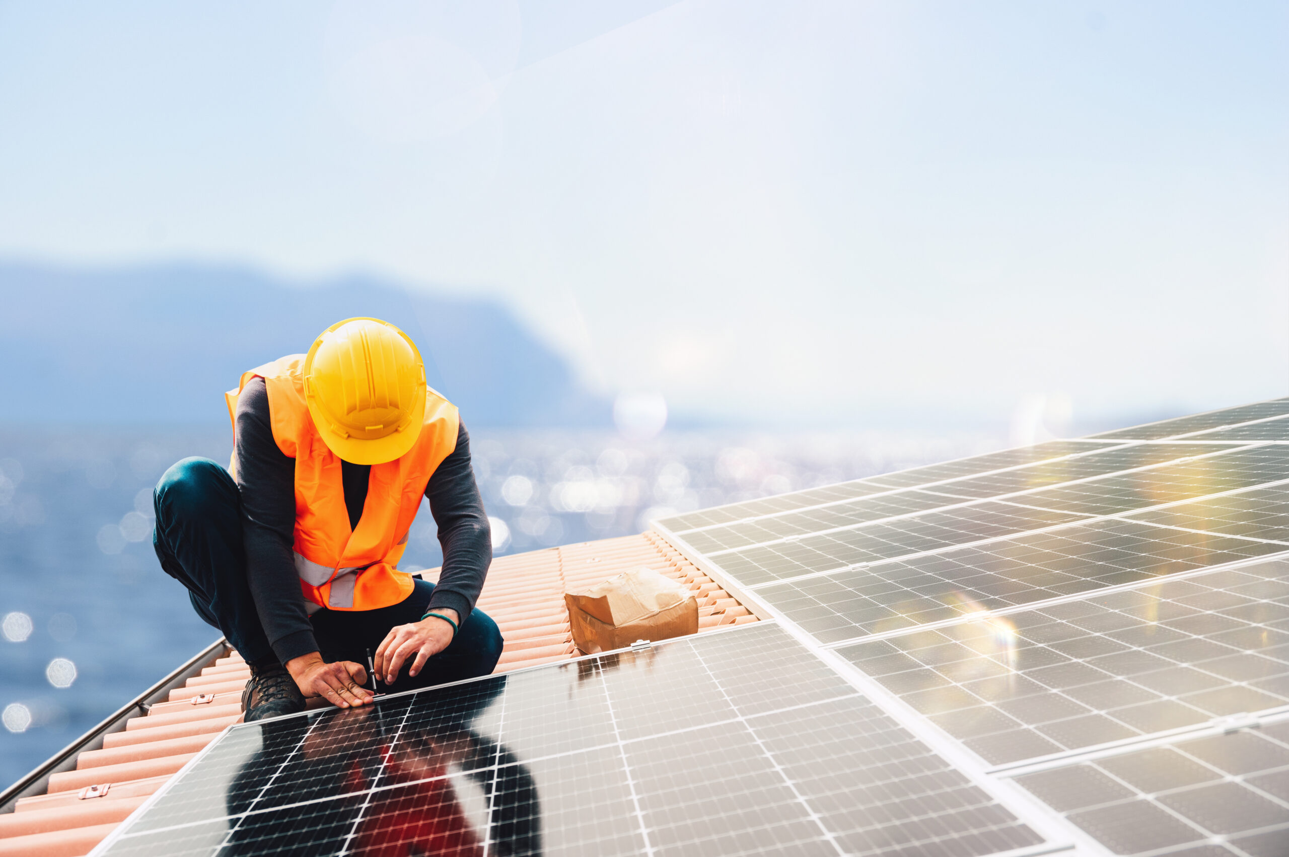 Workers assemble system with solar panel for electricity